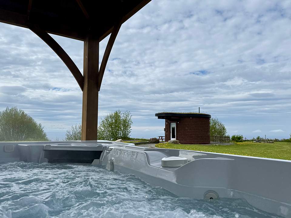 Guests can unwind in the hot tub or by the firepit, then venture out for nearby fishing, hiking, and wildlife viewing adventures.