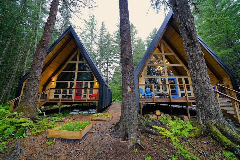 Two a-frame cabins situated in the woods near Seward, Alaska
