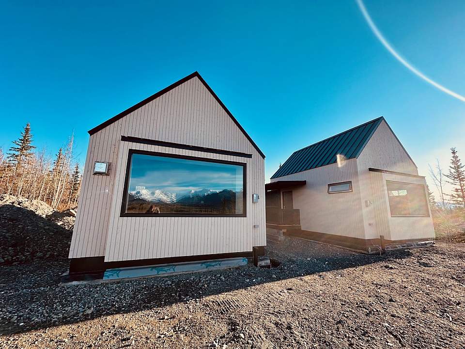 Exterior view of The Great St. Elias Station, a boutique wilderness lodge near McCarthy surrounded by sweeping glacier and mountain scenery in Wrangell–St. Elias National Park.