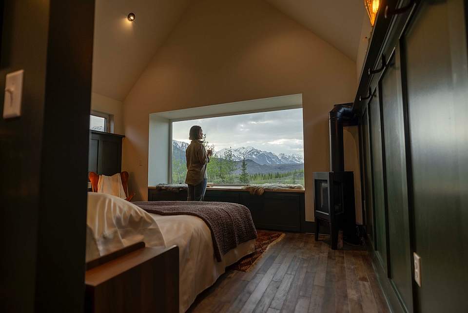 Exterior view of The Great St. Elias Station, a boutique wilderness lodge near McCarthy surrounded by sweeping glacier and mountain scenery in Wrangell–St. Elias National Park.