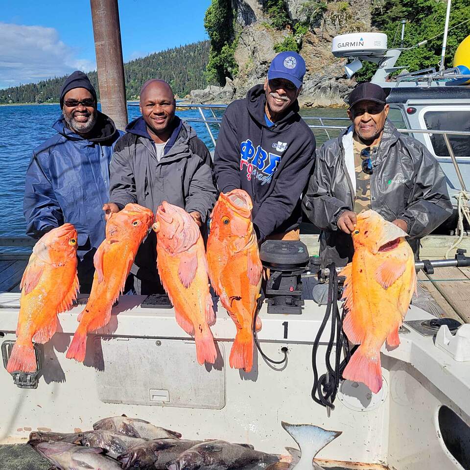 Group of guests showcase their catch of rockfish at the Lodge at Otter Cove