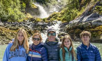 The lodge at whale pass Goulds in front of waterfall vertical Lucas Ryter