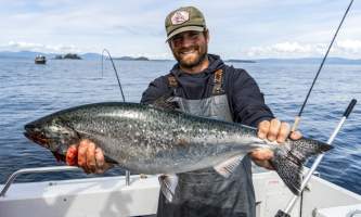 The lodge at whale pass Ty holding up fish to camera Lucas Ryter