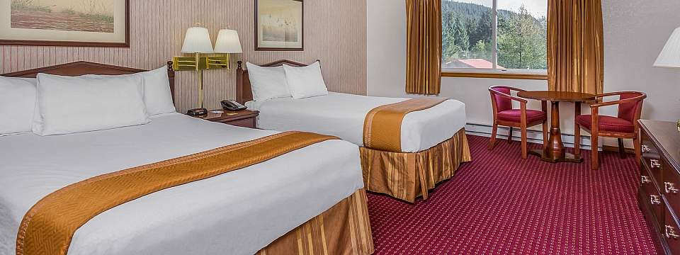 Inside of a guest room with two beds in the Juneau Travelodge hotel.