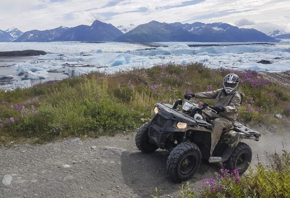 ATV pauses in front of Knik Glacier