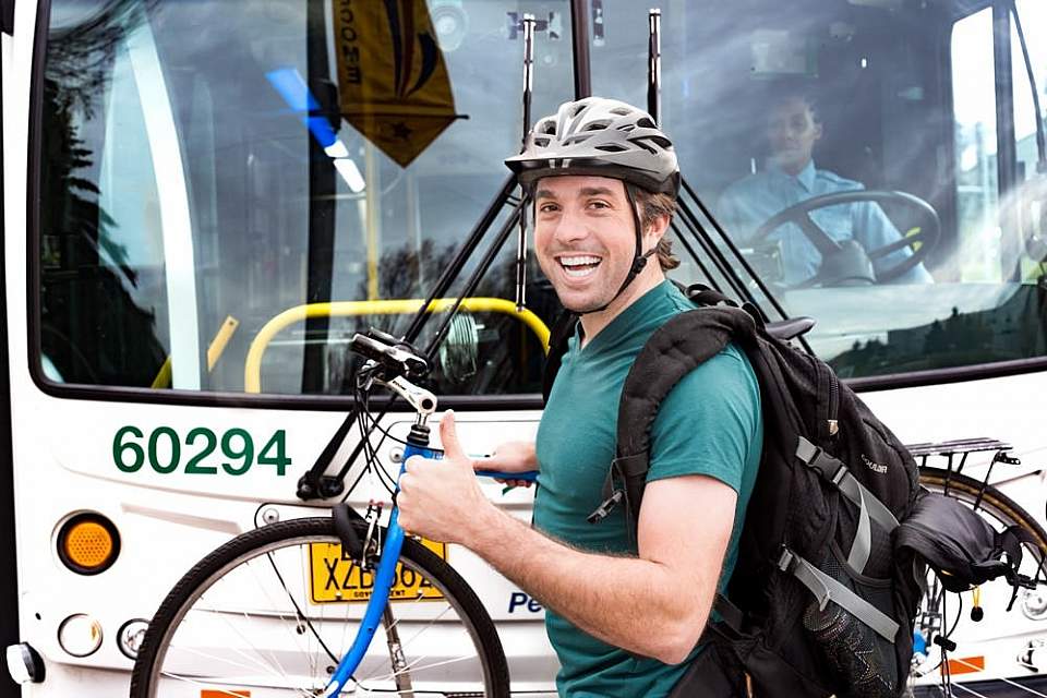 Man loading bike on bus