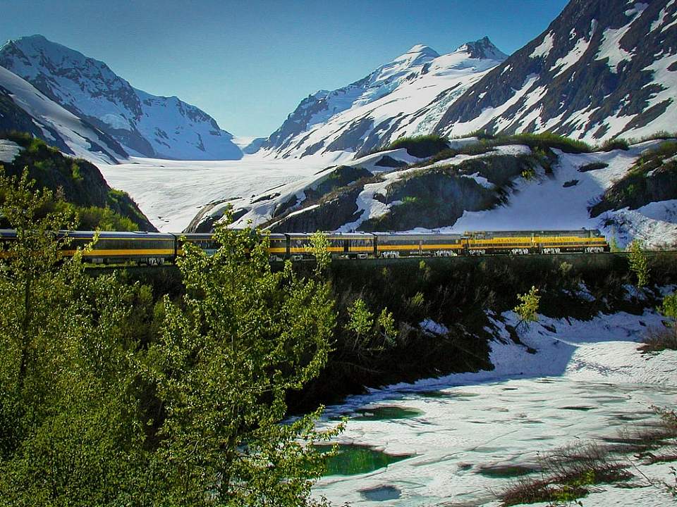 Travel through steep mountain passes, with views of glaciers just out your window